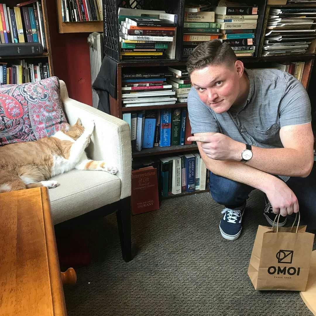 Dillon unsuccessfully trying to pet a Philly bookstore cat